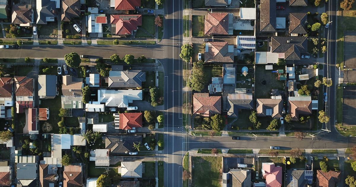 Aerial view of a UK-style residential estate with streets and housing plots