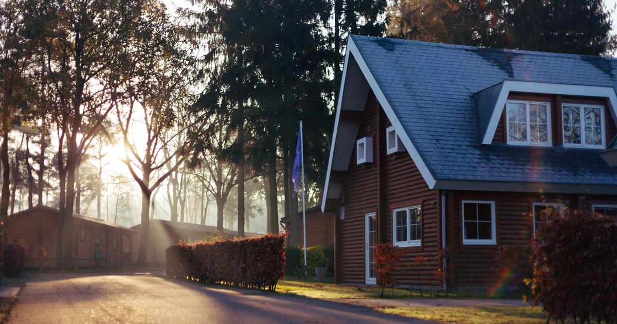 A detached house on a wooded residential plot, typical of land and sites assessed for acquisition
