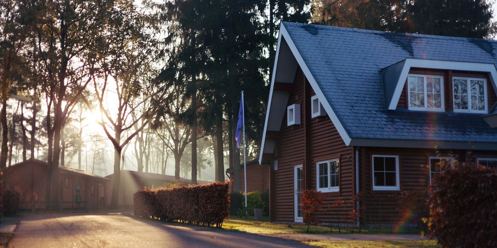 A detached house on a wooded residential plot, typical of land and sites assessed for acquisition